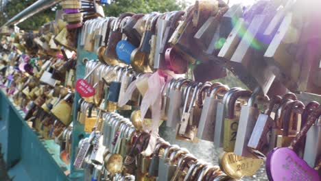 slow pan of love locks on a bridge