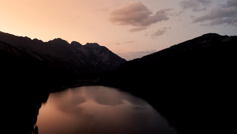 Beautiful-Aerial-View-of-Warm-Sunset-over-Arnensee-Lake,-Switzerland