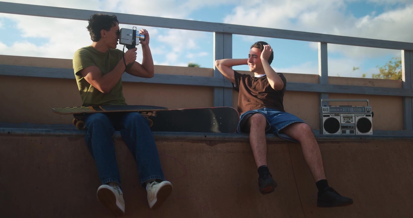 Friends Filming with Vintage Camera and Boombox at Skatepark