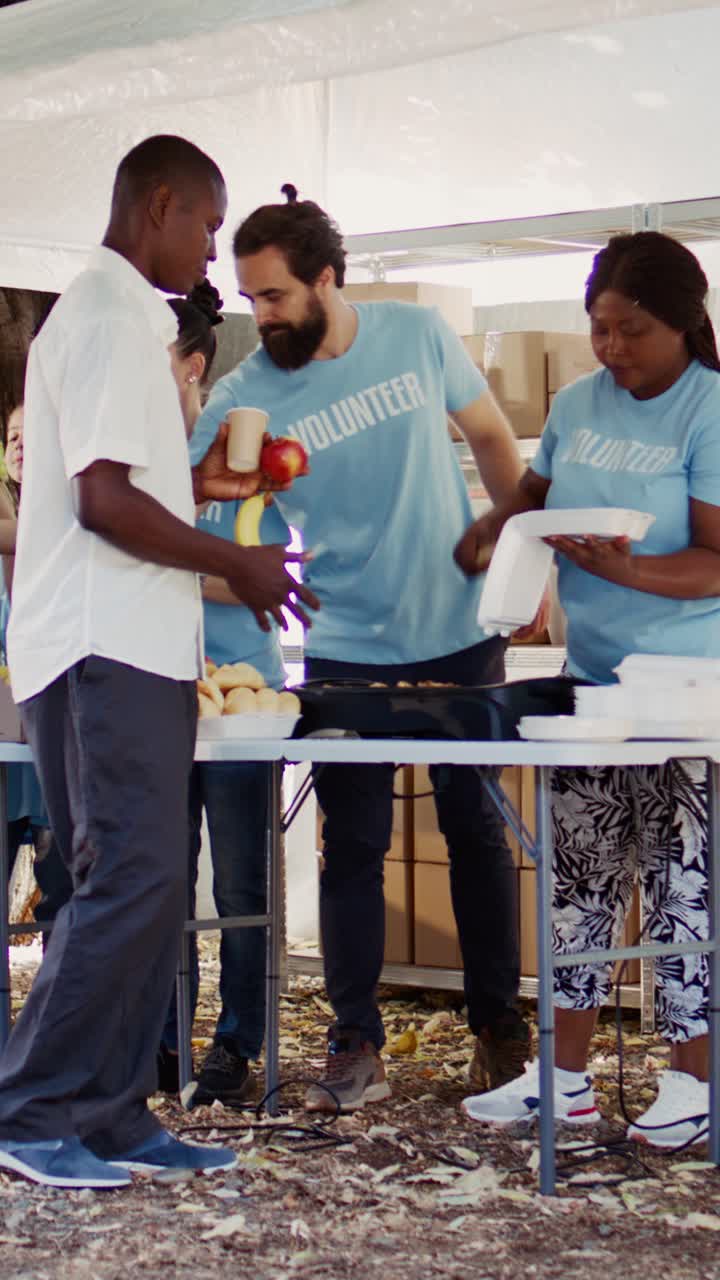 Vertical video Volunteers Serve Warm Meals To The Poor
