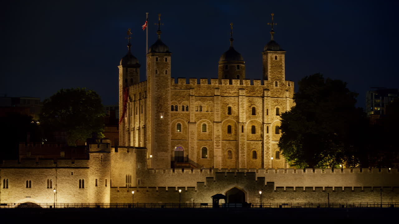 The Tower of London walls lit up warmly in the evening in England