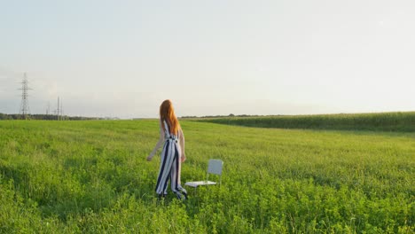 woman in a striped jumpsuit in a grassy field