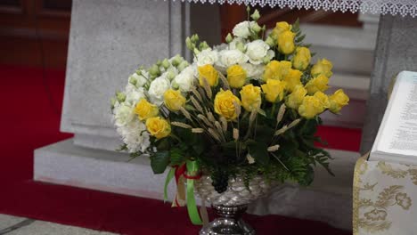 floral arrangement by church altar with open book