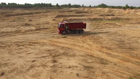 red dump truck in a sand quarry