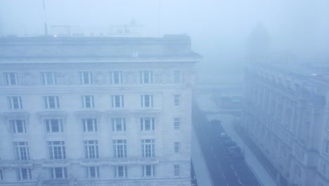 ghostly dense city fog aerial view across haunting downtown magical skyline dolly left