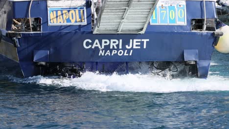 ship leaving port, creating waves in water