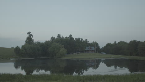 Tilting-up-to-show-a-perfect-peaceful-cabin-on-a-small-pond