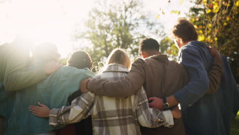 group of friends embracing in sunlight