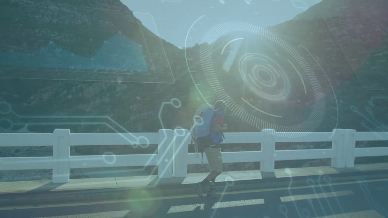 Hiker crossing bridge with digital technology animation over mountainous landscape