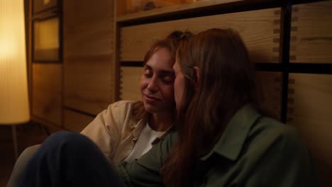 dos mujeres sentadas juntas en un interior acogedor