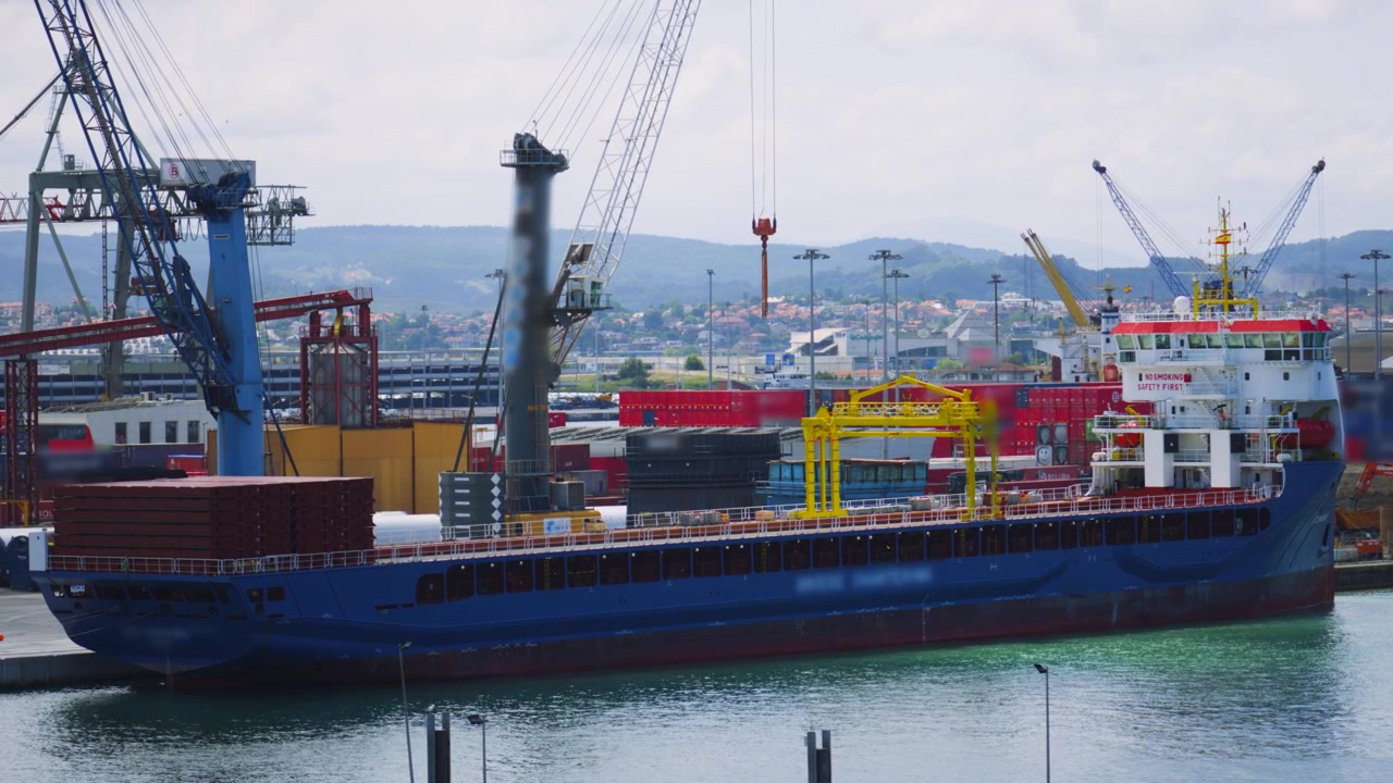 Large Cargo Vessel in Port Ready to Load Containers for Worldwide Distribution from nearby Cranes.