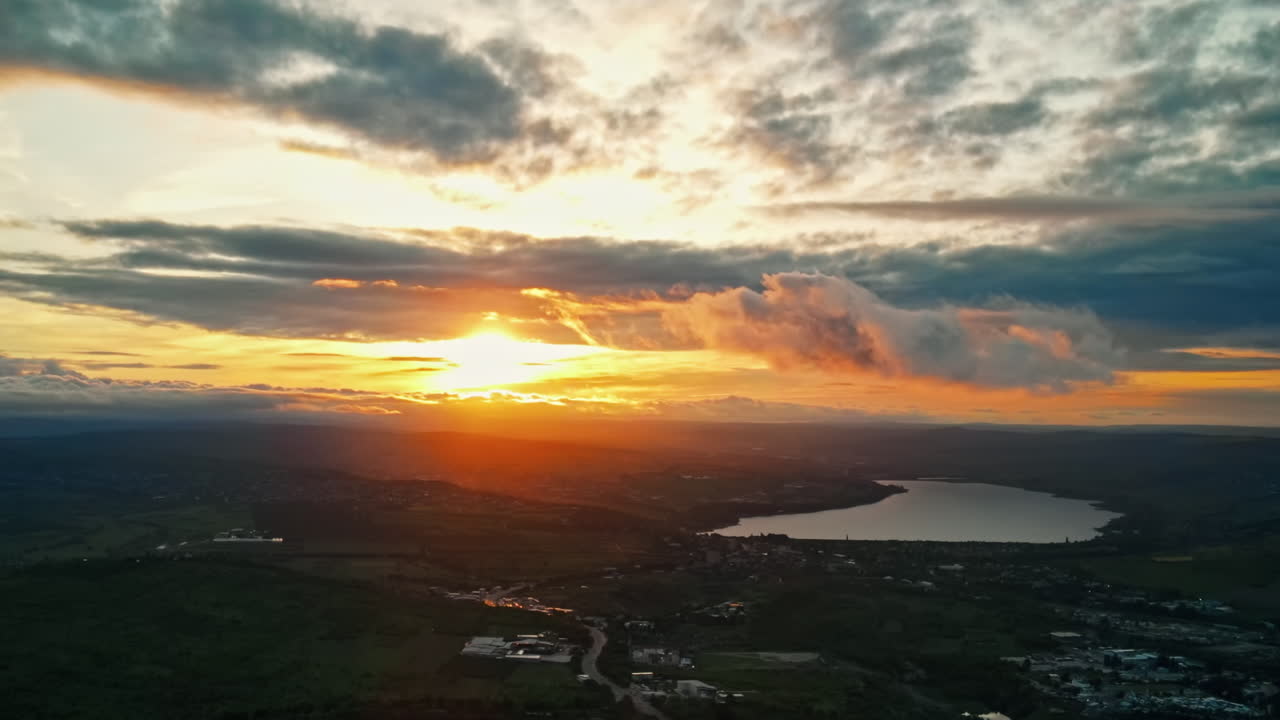 Aerial drone view of Moldova at sunset. Panorama view of hills, greenery, lake, clouds