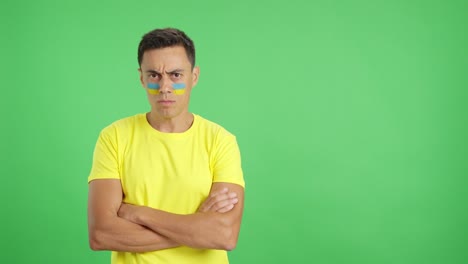 dignified and serious man with ukrainian flag painted on face