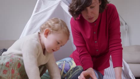 Caucasian-woman-playing-with-baby-at-home