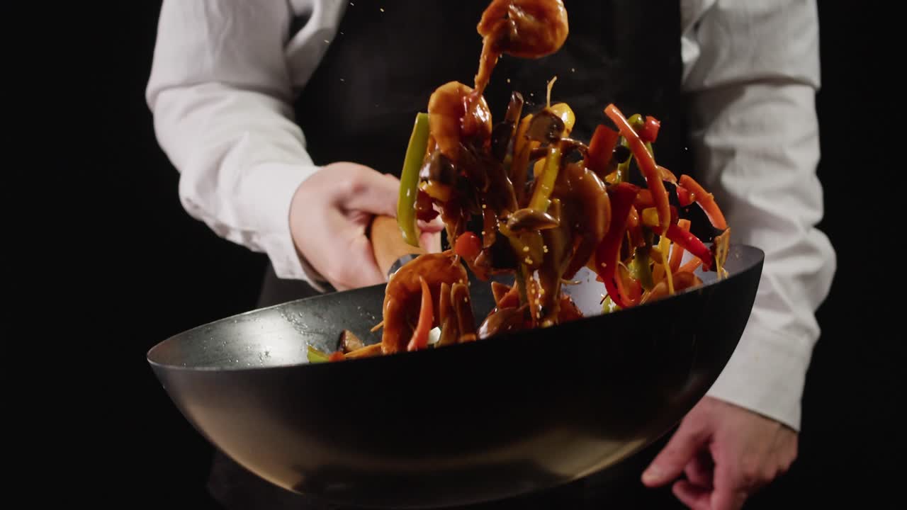 Chef Stir-Frying Shrimp and Vegetables in a Wok