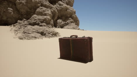 vintage suitcase abandoned in the desert