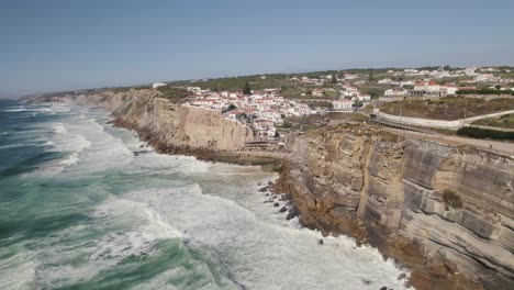 small luxury town of azenhas do mar on rocky cliff coastline, aerial view