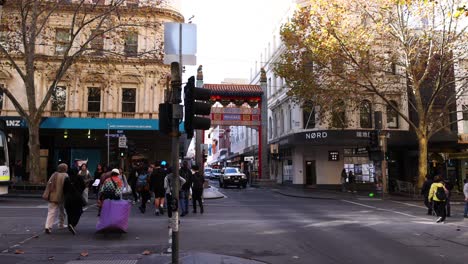 pedestrians crossing street in chinatown, melbourne