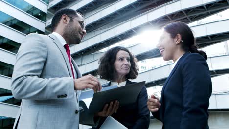 Content-business-people-discussing-papers