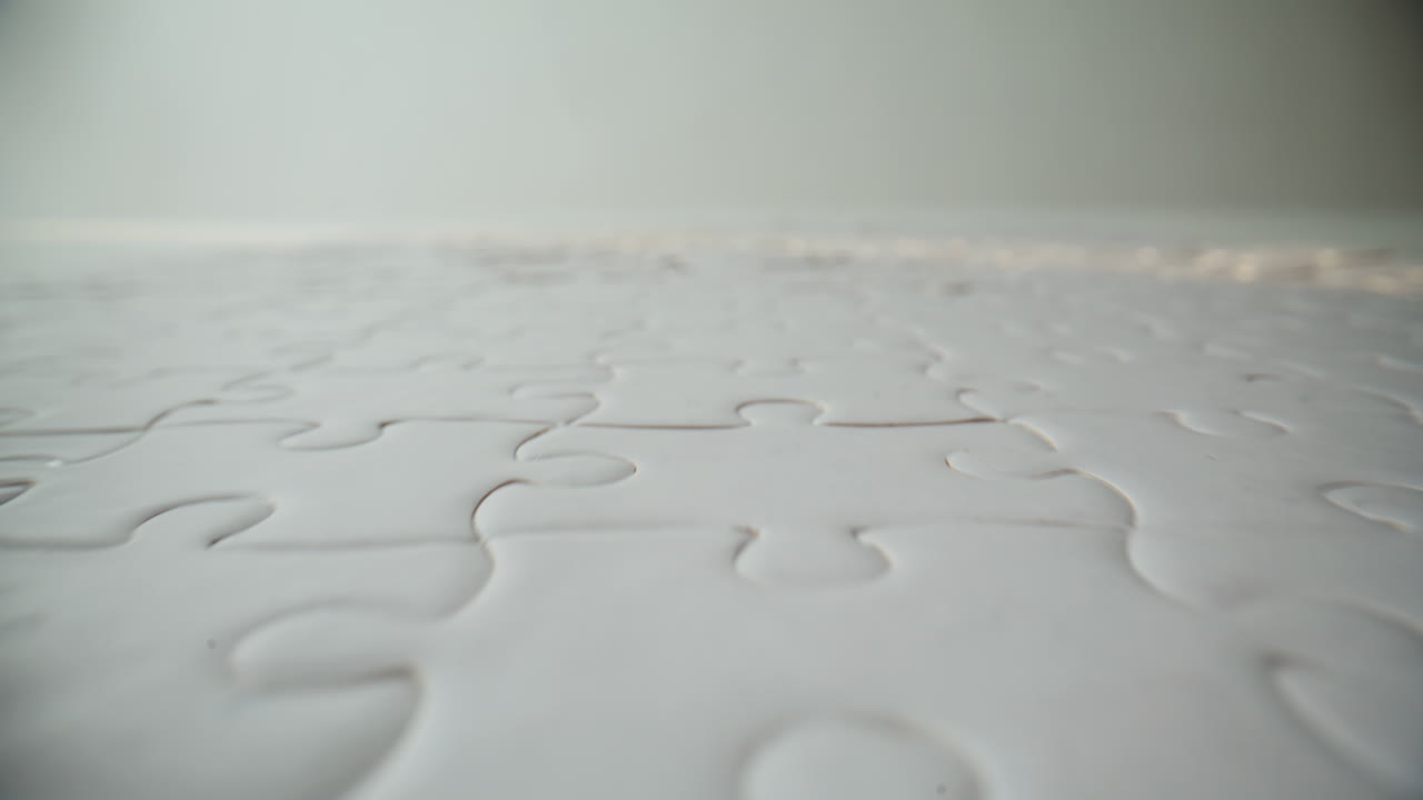 Detailed view finished puzzle on blank table. Mind jigsaw with connected pieces