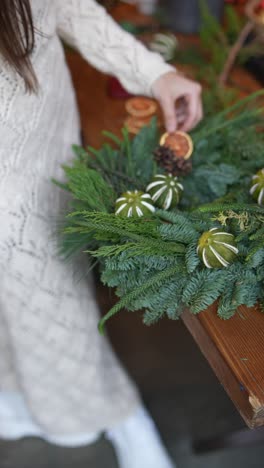 woman making a christmas wreath