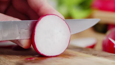 the hands of men with a knife cut pieces from the radishes.