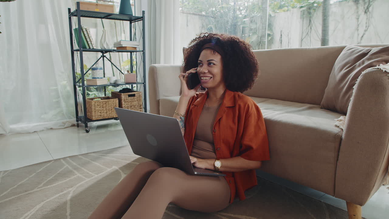 Cheerful Sales Manager Chatting with Colleague on Phone Working from Home
