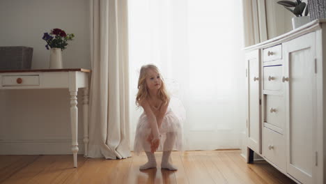 beautiful-little-girl-dancing-playfully-pretending-to-be-ballerina-funny-child-having-fun-playing-dress-up-wearing-ballet-costume-with-fairy-wings-at-home-4k