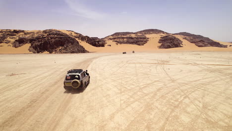 4X4-Vehicles-Driving-In-Sahara-Desert-In-Algeria---drone-shot