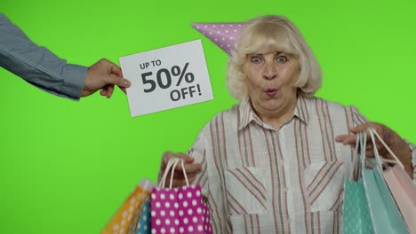 advertisement up to 50 percent off appears next to grandmother. woman dancing with shopping bags