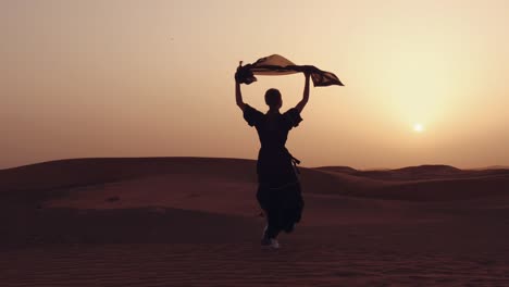 muslim woman standing near mosque in the desert. strong wind middle east peace without war