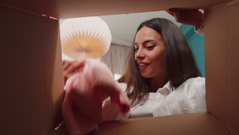 Happy-young-woman-shopper-unpacking-cardboard-box-delivery-parcel-online-shopping-purchase-at-home