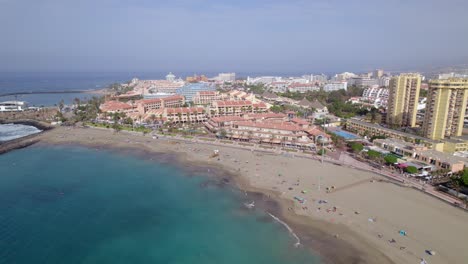 playa de las vistas, tenerife, canary islands, spain, drone aerial view of sandy beach, upscale hotel resorts and waterfront buildings on atlantic ocean