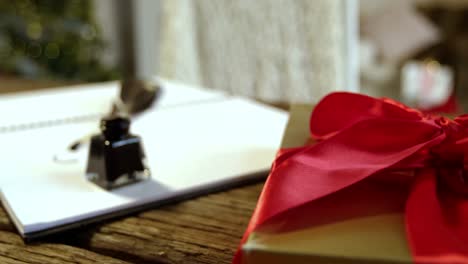 close-up of gift box, diary, ink bottle and quill