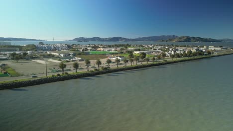 pan drone shot of treasure island cityscape with pacific ocean in the day in california, usa