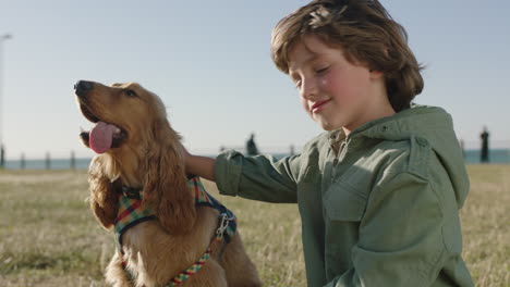 close up portrait of cute caucasian boy petting dog gentle care smiling happy enjoying sunny day at seaside park