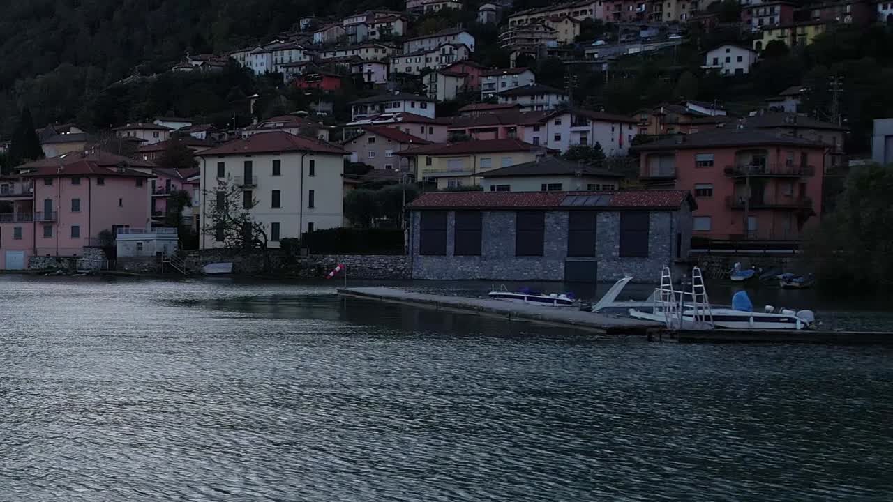 Stunning aerial view of Italian Alps by a tranquil lake at dusk