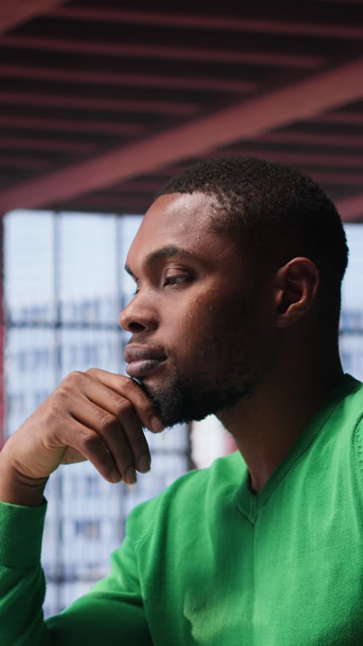 Vertical Video Black teleworker being pensive thinking about solutions to make more money