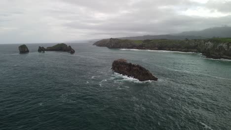 Aerial-view-of-an-island-in-the-ocean-with-cloudy-sky