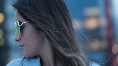 girl posing wearing with big round sunglasses at night in the evening