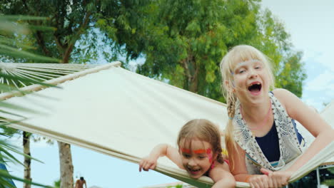 Little-Children-With-Aqua-Grim-On-Their-Faces-Skate-Happily-On-A-White-Cloth-Hammock-On-The-Beautifu