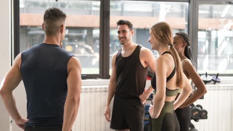 group of friends talking in a gym