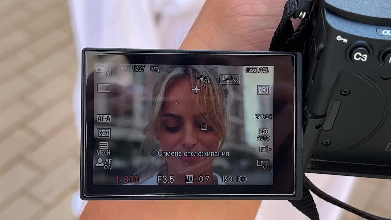 Close-up of a camera screen displaying a portrait
