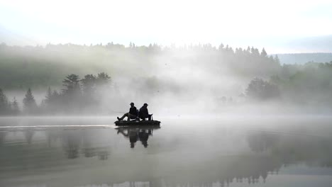 fishermen fishing on misty lake in the morning
