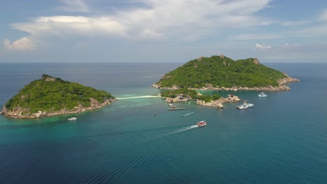 aerial view of a tropical island with boats and clear blue water