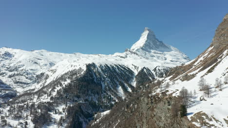 aerial dolly of a large swiss valley with the matterhorn in the background