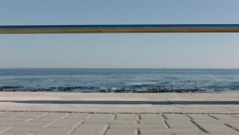 woman legs walking on seaside pier enjoying relaxing summer vacation in beautiful ocean background