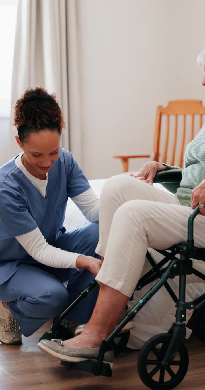 Caregiver Assisting Elderly Woman in Assisted Living Facility
