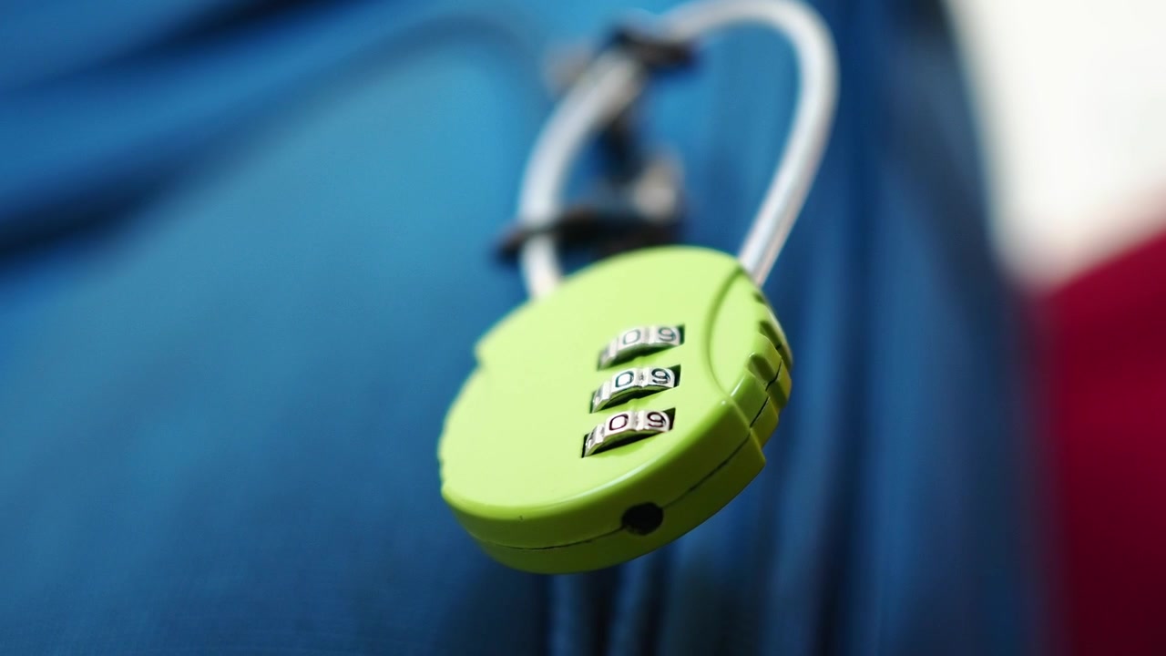 Lucchetto a Combinazione Verde Chiuso su Valigia Blu