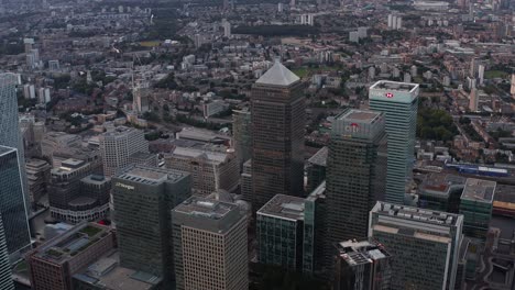 aerial view of tall modern building around canada square in canary wharf business district. canada, hsbc, citi and other office skyscrapers after sunset. london, uk